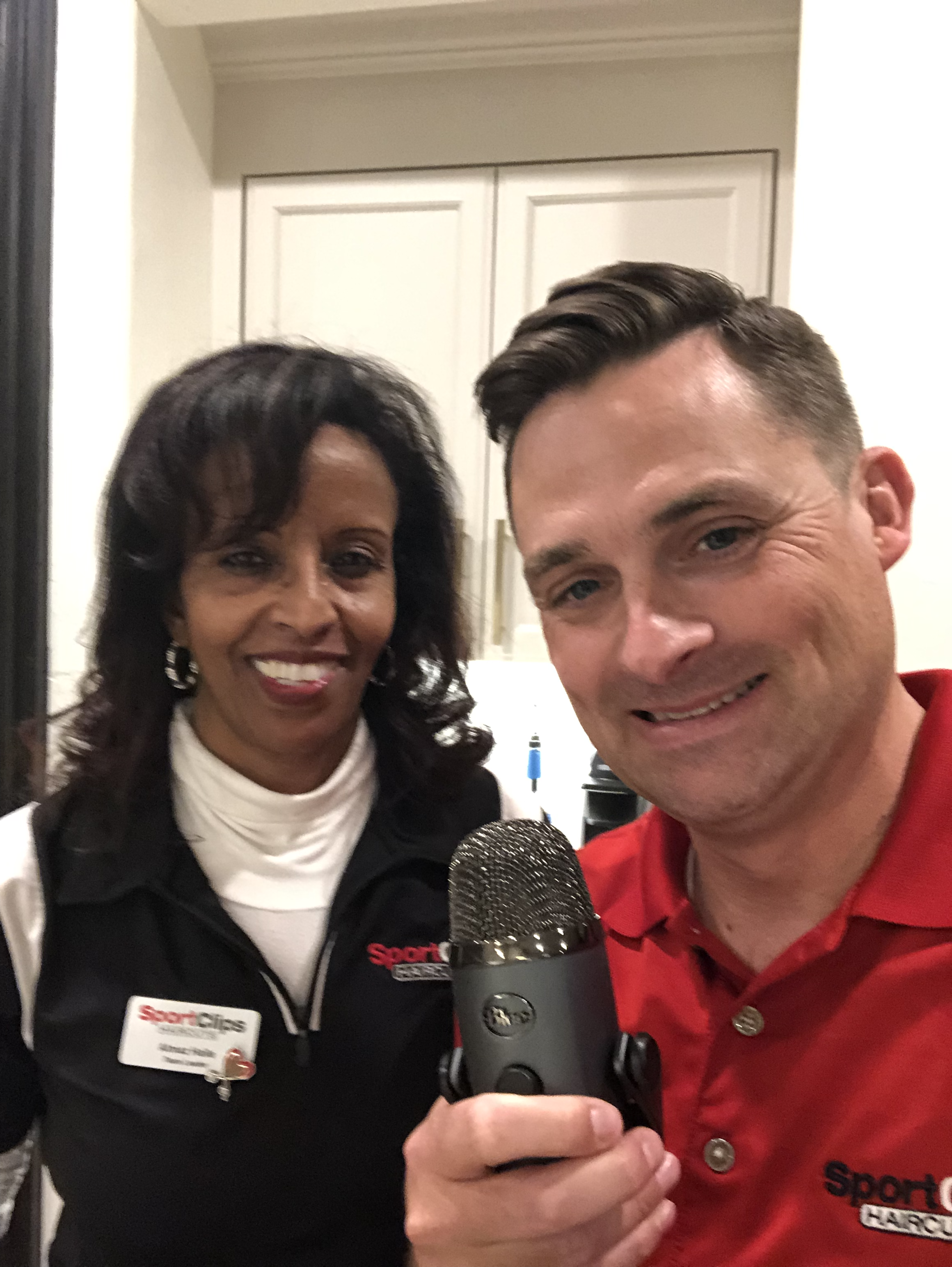 Chad Jordan and Almaz Haile holding a microphone